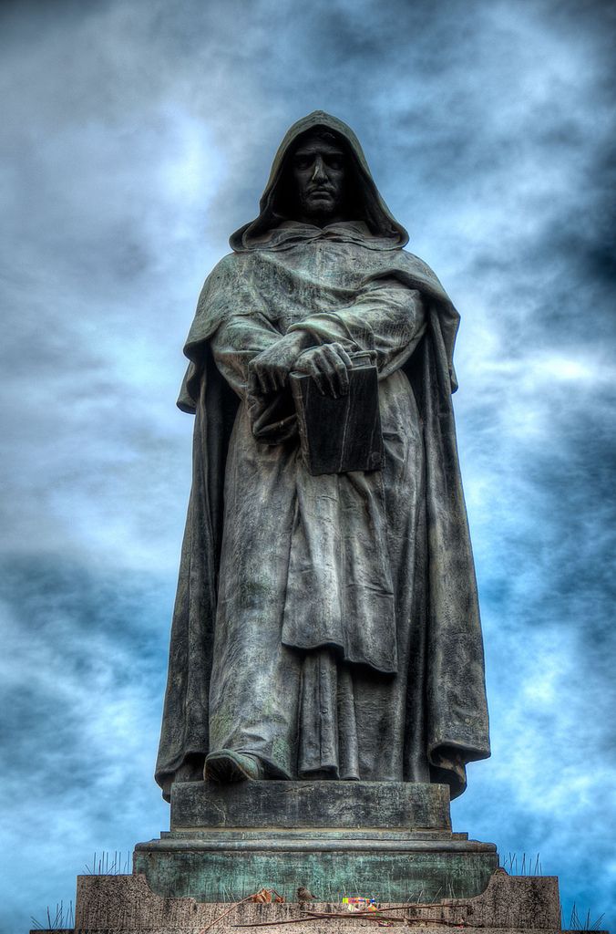 the statue is standing in front of a cloudy sky