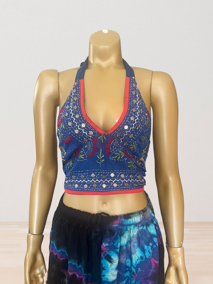 This vibrant, hand-embroidered bikini halter top offers stylish Boho-inspired fashion with its colorful threads and sequin embellishments. Paired with jeans or a skirt, this is the perfect summer top to stand out in and make a statement. The lining is a contrasting color to give it a unique, eye-catching look. One Size Made in India Care Instructions: Dry clean only Girl In The Mirror, Colorful Threads, Upcycle Design, Design Clothes, Inspired Fashion, The Mirror, Summer Top, Perfect Summer, Halter Top