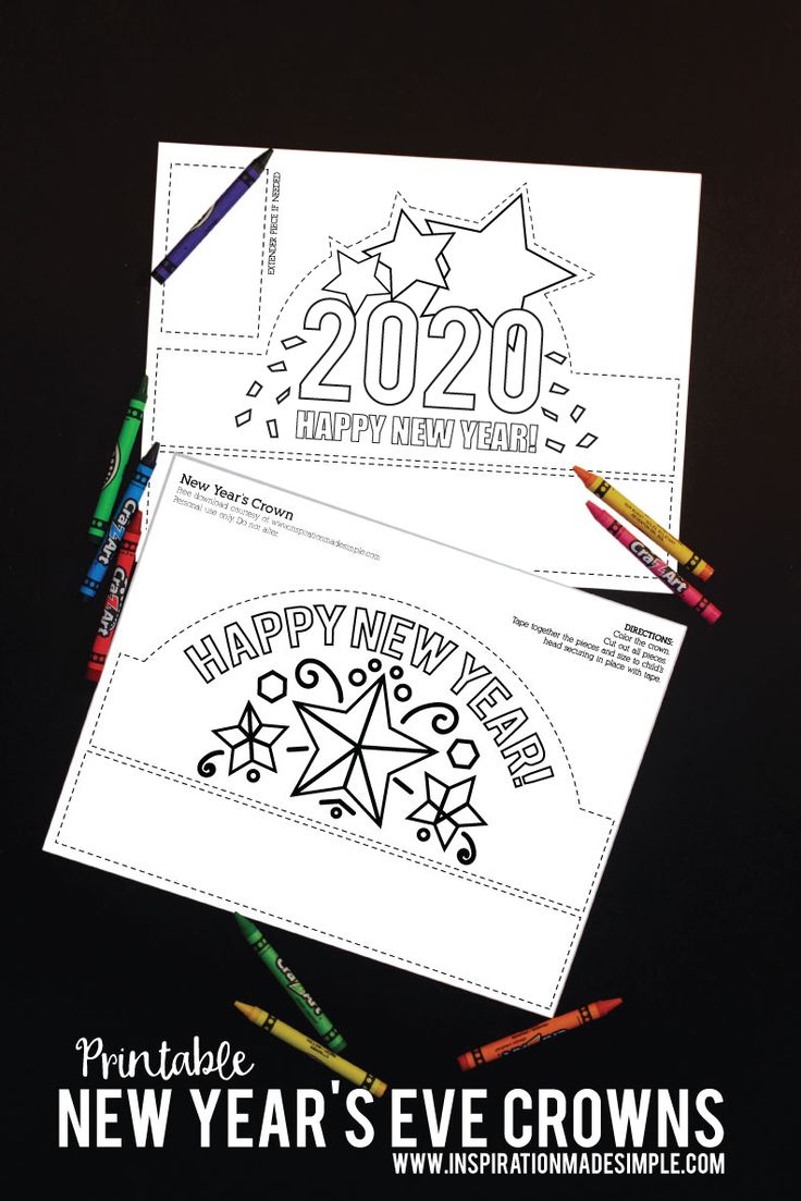 two new year's eve crowns with colored crayons on the bottom and an envelope that says happy new year