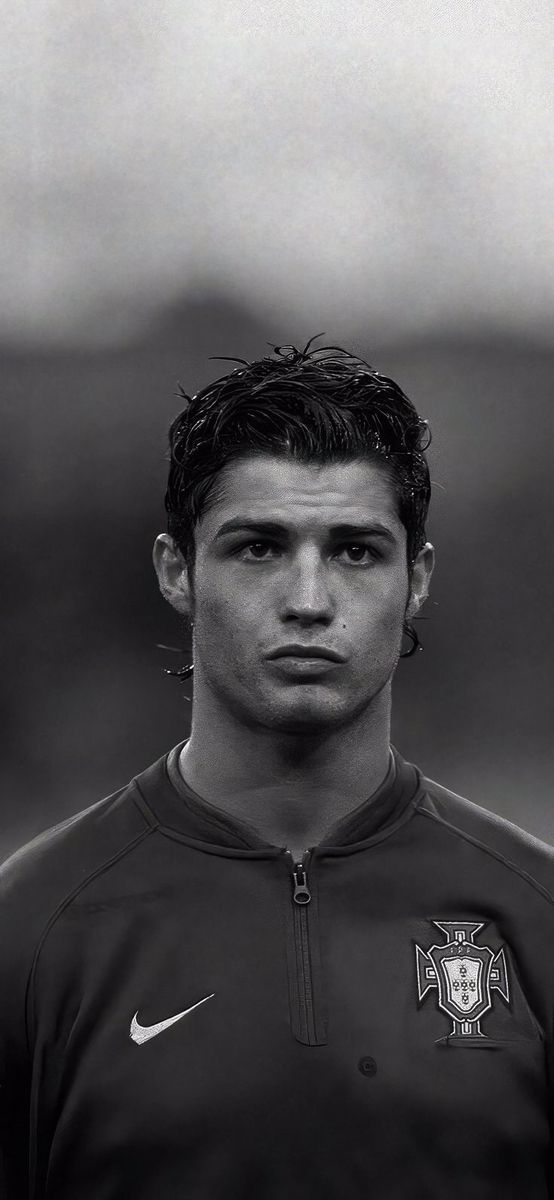 a young man is posing for a photo in black and white with his head turned to the side