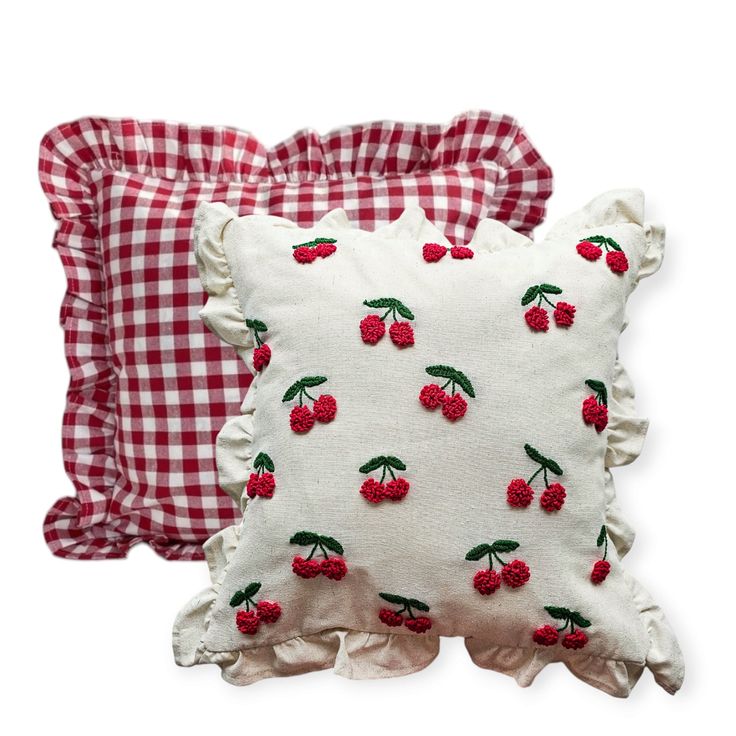 two pillows with cherries on them and gingham