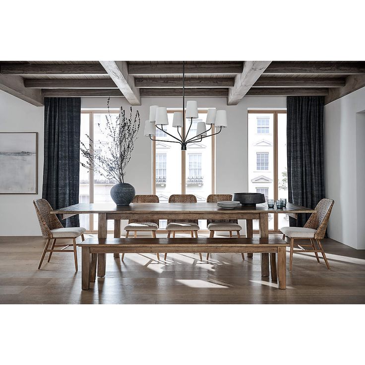 a dining room table with chairs and a bench