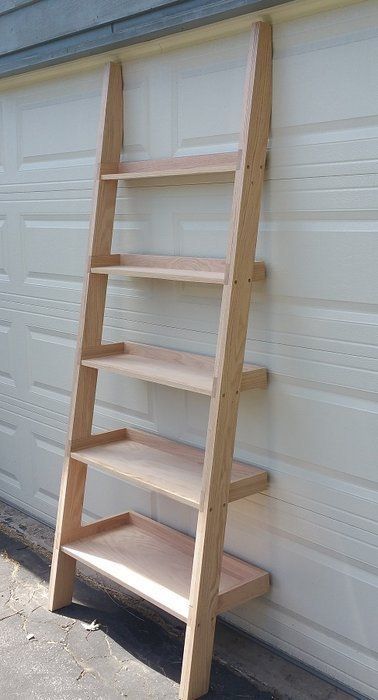 a wooden ladder leaning against a garage door