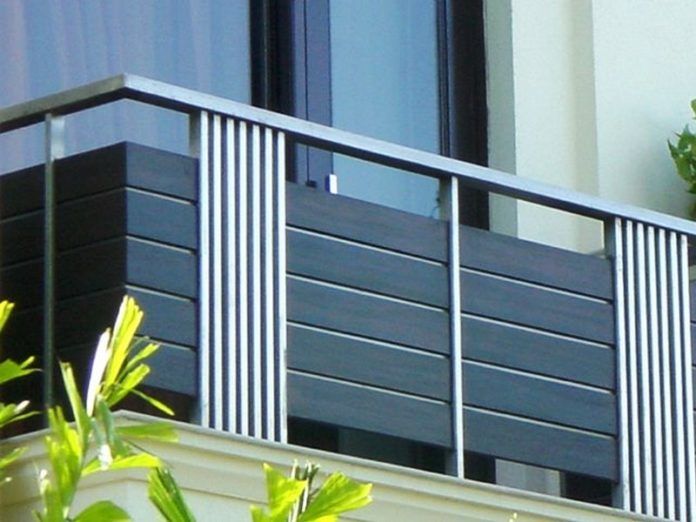 an apartment building with balcony railings and plants