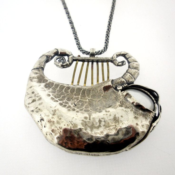 "This unique pendant is made of sterling silver and a beautiful shell. This stunning piece is the perfect gift for yourself or a loved one. DIMENSIONS - Max Length: 48 mm / 1.92 inches - Max Width: 55.5 mm / 2.22 inches - The length of the chain is usually 18\"- 22\", yet can be made at any size you wish. - If you are interested in a specific length, please write a note on checkout. NOTES -  It comes in a beautiful jewelry gift box. - We can also add a personal note in case you would like us to Silver Hammered Pendant Jewelry, Hand Cast Silver Artisan Necklace, Hammered Sterling Silver Necklaces In Silver, Unique Silver Hammered Jewelry, Unique Hammered Silver Jewelry, Hammered White Gold Pendant Necklace, White Gold Hammered Pendant Necklace, Artistic Silver Necklaces With Polished Finish, Spiritual Hammered Sterling Silver Necklaces