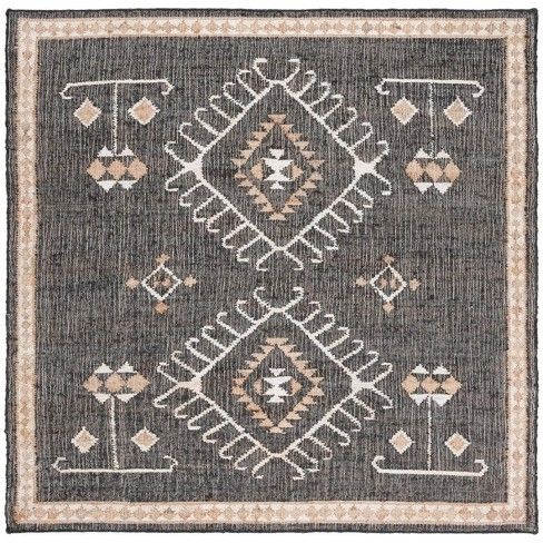 a gray and white rug with an intricate design on the front, in different colors