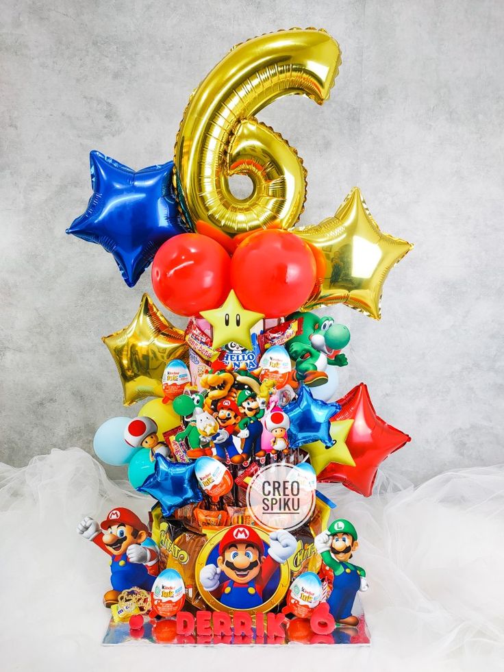 a bunch of balloons that are in the shape of a birthday cake with mario and friends on it