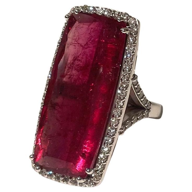 Description This striking 25.5 carat elongated emerald cut Red Tourmaline ring is embellished with 1.32 carats pave diamonds, and is set in a 14k white gold Y-shape band. Item #R180 Materials and Weight Red Tourmaline 25.5 cts 31.2x13.8x7.1mm, elongated emerald cut. Diamonds 1.32 cts 14k white gold Dimensions Size 7 Band width 3mm Made in Newport Beach, California. USA Red Tourmaline, Newport Beach California, Pave Diamond Ring, Tourmaline Ring, Beach California, Fine Jewels, Newport Beach, California Usa, Cocktail Rings