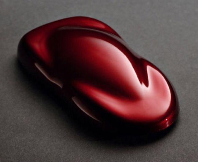 a shiny red object sitting on top of a table