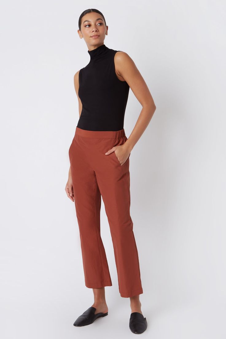 Fall calls for ease with our elastic waist Brit Crop Pant. With a mid-rise fit, angle seam pockets and the perfect leg opening, this style is a breeze to wear in the cooler weather. Pair it with your favorite ankle boot or sneaker, this style is designed for women on the go.THIS ITEM IS FINAL SALE. 1.5" front waistband, elastic at sides and back, angle seams with front pockets, midrise, easy fit, clean finish hem. - 51% Cotton, 49% Nylon - Fabric Woven in Italy - Made in NYC - Professional dry c Fitted Straight Pants With Pull-on Style, Business Casual Straight Dress Pants With Pull-on Style, Fall Bottoms With Pull-on Style And Tapered Leg, Casual Straight Leg Pull-on Dress Pants, Fall Relaxed Fit Pull-on Pants, Relaxed Fit Pull-on Pants For Fall, Fall Business Casual Pants With Minimal Stretch, Casual Wide Leg Pull-on Pants For Business, Versatile Pull-on Pants For Business Casual