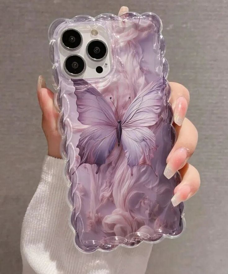 a woman holding an iphone case with a purple butterfly on it