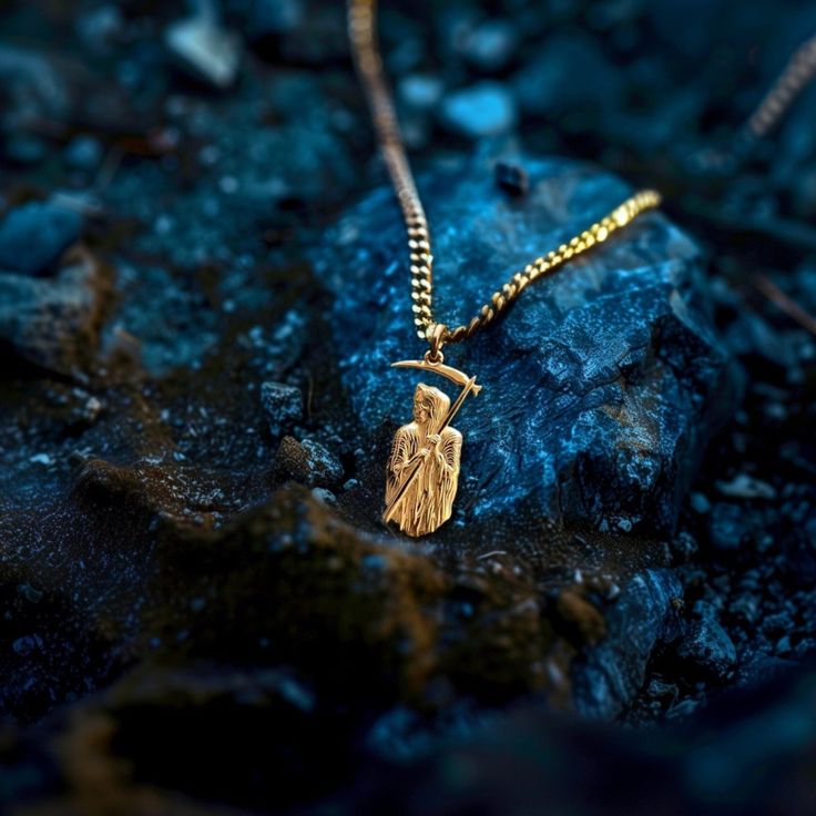 Our Gold Santa Muerte Pendant, crafted in the USA from real solid gold, embodies devotion and protection. This timeless piece showcases exquisite craftsmanship, designed to last a lifetime. Perfect for those seeking a unique and meaningful symbol, this pendant is a testament to enduring quality and elegance. PENDANT INFORMATIONThis pendant is made of real, solid gold.• Made in USA• Material: 14k or 18k solid gold• Finish: polished• Height: 1.46" (37 mm) x Width: 0.67" (17 mm)• Pendant weight: approx. 6 grams (14k)• Bail: fits up to 4 mm chains• Solid back, not hollow• A certificate of authenticity is included• Delivered in our elegant jewelry box, making it the perfect gift Shipping: All of our orders are custom-made. Please allow approximately 3 weeks for production and shipping. Shipping Egyptian Jewelry, Solid Gold Chains, White Gold Chains, Box Making, Yellow Gold Pendants, Elegant Jewelry, Gold Finish, Gold Pendant, 3 Weeks