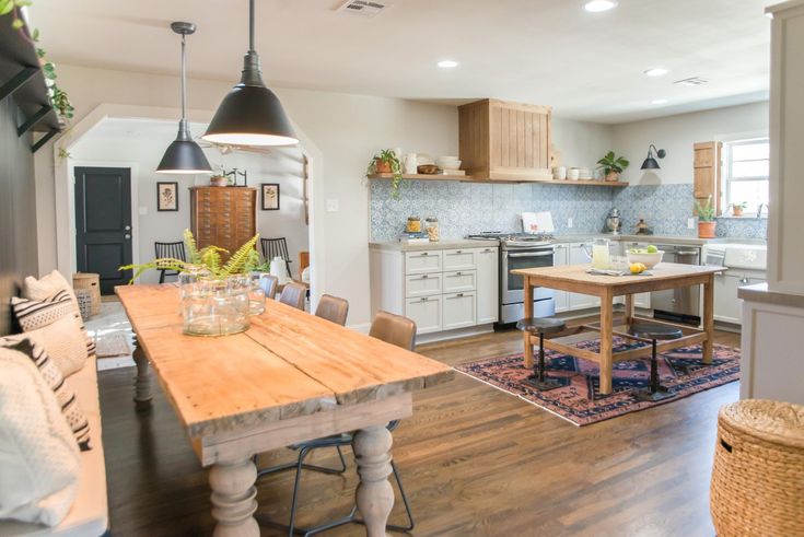 an open concept kitchen and dining room with wood flooring