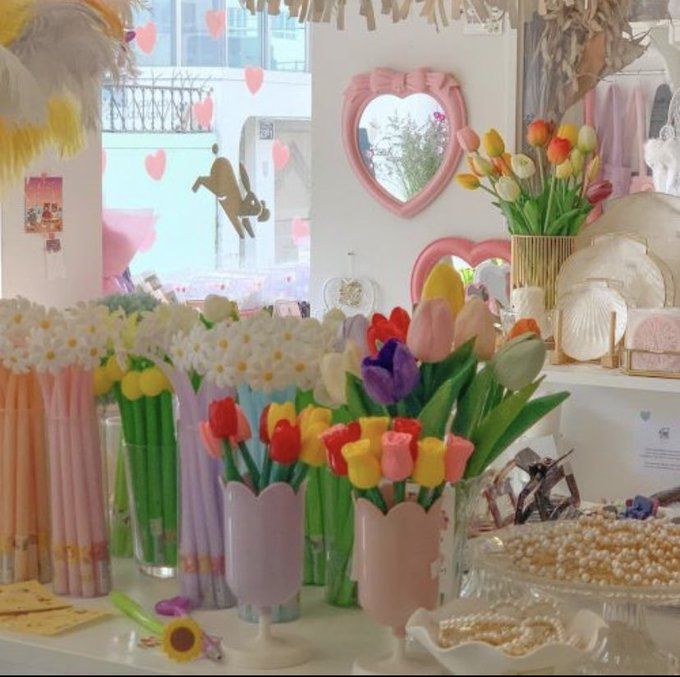 there are many different vases with flowers in them on the table next to each other