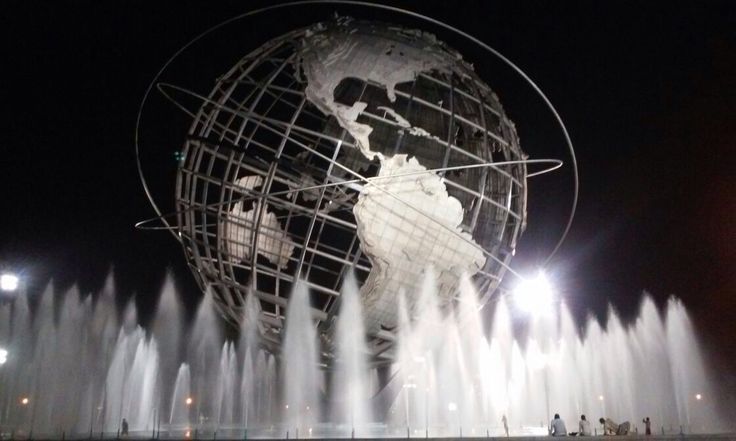 the world is surrounded by water fountains at night