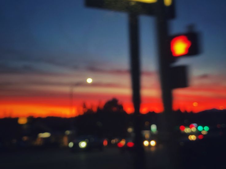 a traffic light sitting on the side of a road next to a red street sign