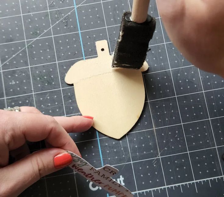 someone is cutting out an ornament for a craft project