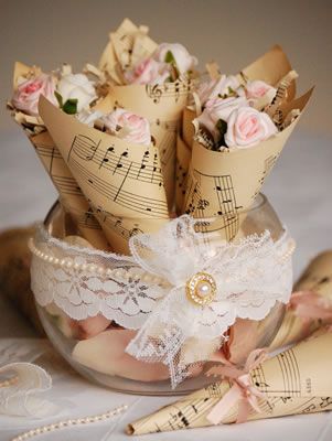 a vase filled with roses and music notes