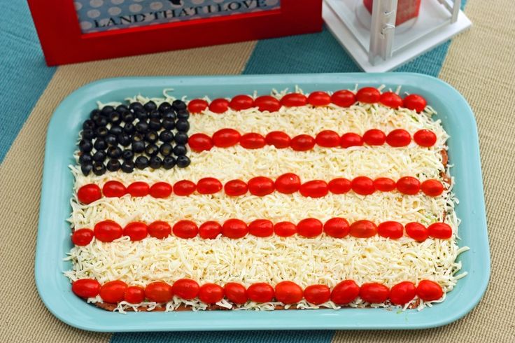 an american flag cake with cheese and tomatoes in the shape of the united states on it