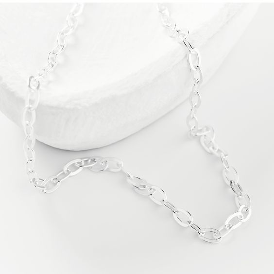 this silver chain can be worn alone as a simple, subtle statement or as a layering piece. White Link Necklace With Silver Chain, Silver Cable Chain Link Necklace, Simple Silver Delicate Chain Necklace, Simple Silver Chain Necklace As Gift, Simple Silver Chain Necklace Gift, Minimalist Silver Necklace With Oval Link, Minimalist Silver Oval Link Necklace, Minimalist Silver Chain Necklace For Everyday, Everyday Sterling Silver Charm Necklaces