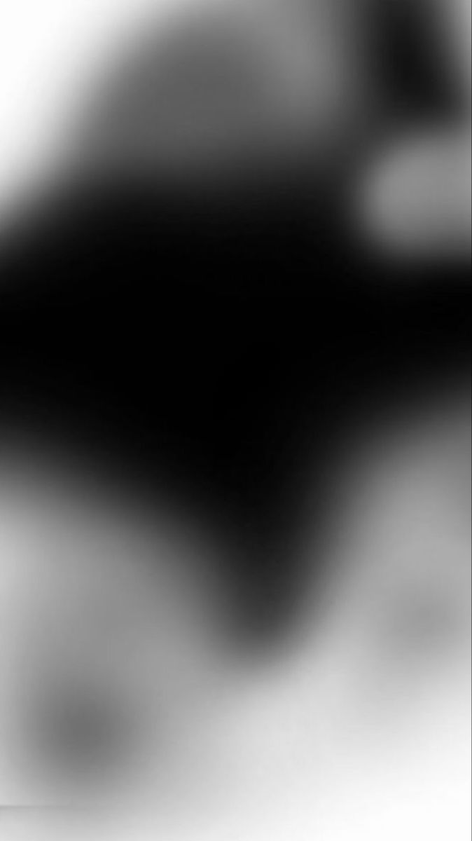 a blurry image of a black and white cat