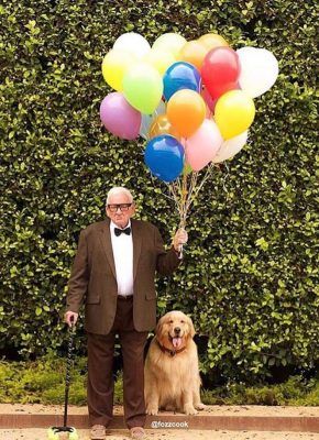 a man in a tuxedo and bow tie holding balloons next to a golden retriever