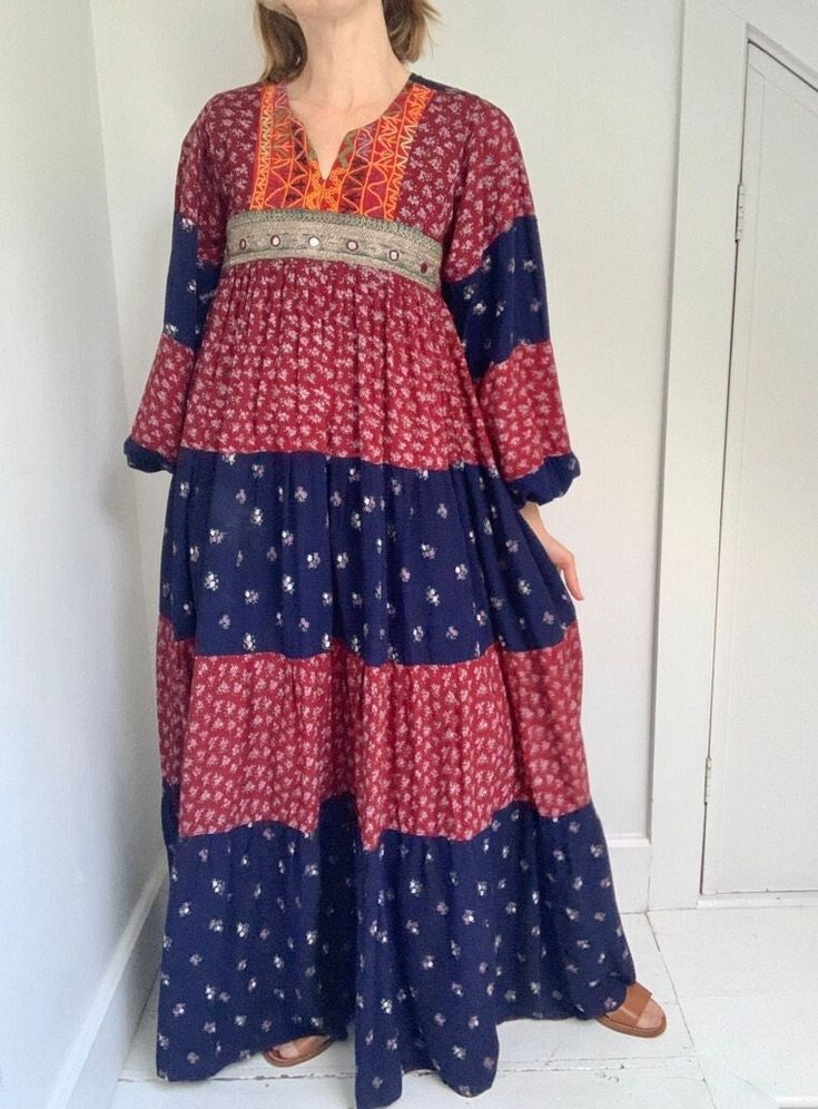 "Dreamiest 70s balloon sleeve bohemian patchwork dress. Feels like cotton, with empire waist and tiered skirt. Mirror work and embroidered at bodice. Size: No size tag; fits XS/S best Measurements: pit to pit 16.5\" / length 55.5\" / empire waist 32\" / natural waist 48\" / shoulder 14\" / sleeve 28\"  Condition:  Some patina to wrist snaps, otherwise mint condition *All measurements taken laying flat (waist doubled) to ensure fit, compare to a piece you already own. no refunds given if an item Bohemian Maxi Dress With Floral Patchwork, Bohemian Blue Patchwork Maxi Dress, Bohemian Maxi Dress With Patchwork, Red Bohemian Patchwork Dress, Bohemian Red Patchwork Dress, Bohemian Long Sleeve Patchwork Dresses, Bohemian Patchwork Dresses For Fall, Afghan Fashion, Afghan Clothes