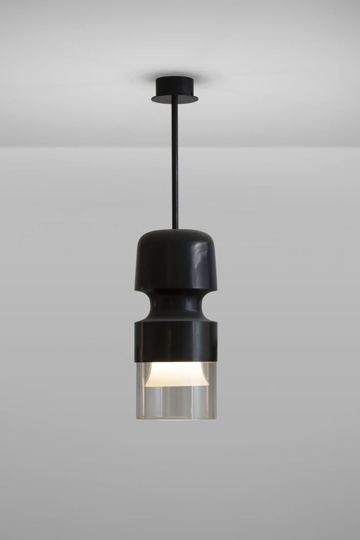 a black and white light hanging from a ceiling