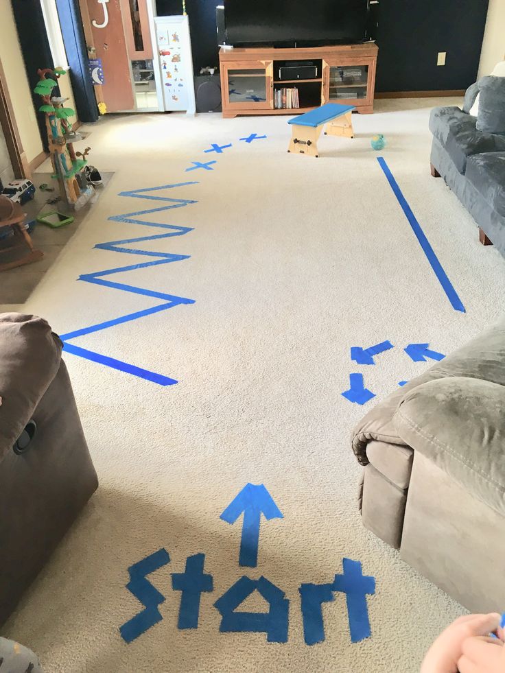 a living room with blue arrows painted on the floor