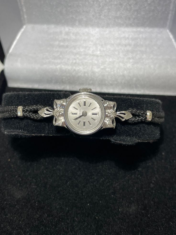 "Zodiac ladies 14kt white gold diamond wristwatch. This unique style watch features a textured bow set with a diamond in the center on the top and bottom of the case. 17 jewel wind up style watch with 17 jewel mechanical movement is in good working condition and keeps accurate time. This antique watch has been well cared for it still has the original winding crown. Custon fit for a 6.25\" wrist with a cord style band that I can make smaller but not larger. Beautiful working vintage solid gold ti Native American Turquoise Ring, Antique Watch, Cute Watches, Antique Watches, Style Watch, Fancy Diamonds, Bow Set, Mechanical Movement, Women Wrist Watch