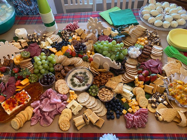 a table topped with lots of different types of cheeses and crackers on top of it