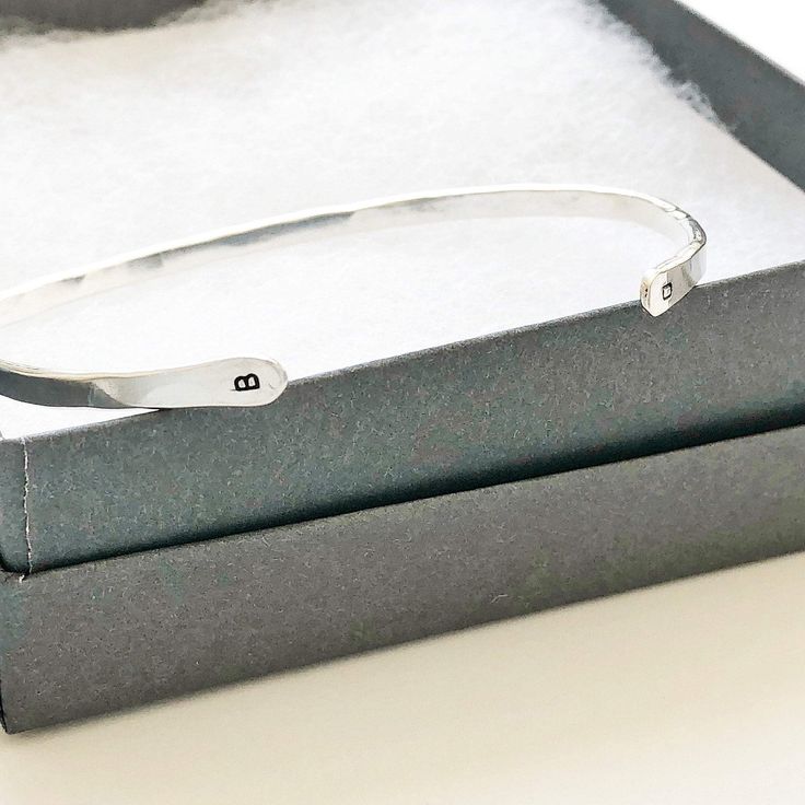 Our "Charlie" bangle with initials is understated, delicate and simple. Perfect for you or a gift for someone special. - Initials at each end of the bangle make it extra special. You can add a first and last initial. - We make these by hand so each one has its very own personality - One size fits most - A 6.5 inch bracelet with 1 inch opening that can be squeezed open or closed - Please message us at hello@sarahcornwelljewelry.com if you need a custom size. - all pieces are Sterling Silver or 14 Personalized Sterling Silver Initials Bracelet, Sterling Silver Initials Bracelet For Personalized Gift, Classic Initials Bracelet, Perfect As Gift, Classic Personalized Initials Bracelet, White Gold Initials Bracelet For Anniversary, Modern Adjustable Jewelry With Initials, Modern Adjustable Initials Jewelry, Sterling Silver Bracelets With Initials For Anniversary, Minimalist Name Bangle Bracelet As Personalized Gift