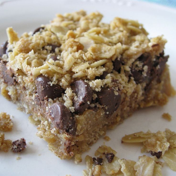 a close up of a piece of food on a plate with crumbs around it