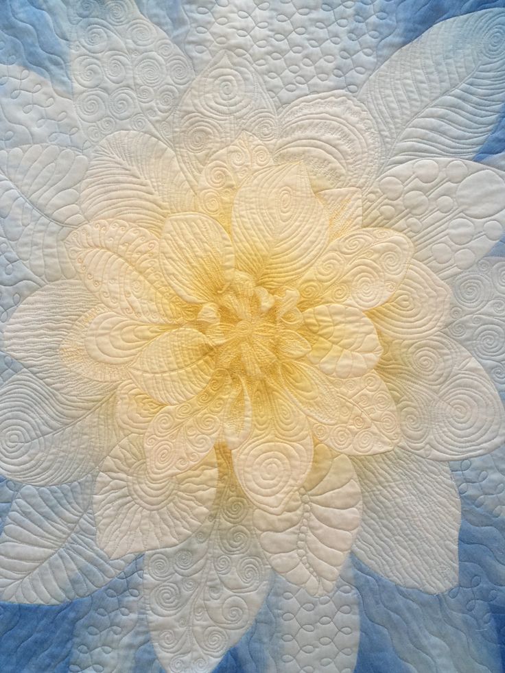 a large white flower on top of a blue background