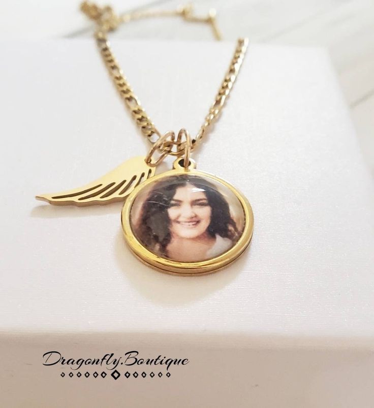 14k Gold Photo Necklace with Angel Wing. Pendant is 20mm in Size. Chain 3mm thick. Gold Plated on Stainless Steel. High Quality. Does Not Tarnish Personalized Round Jewelry For Commemoration, Personalized Gold Jewelry For Memorial, Customizable Rose Gold Jewelry For Memorial, Gold 14k Memorial Necklace, Personalized 14k Gold Jewelry For Memorial, Gold Round Pendant Charm Necklace For Memorial, Gold Pendant Charm Necklace For Memorial, Personalized 14k Gold Memorial Jewelry, Memorial Gold Engraved Charm Necklace