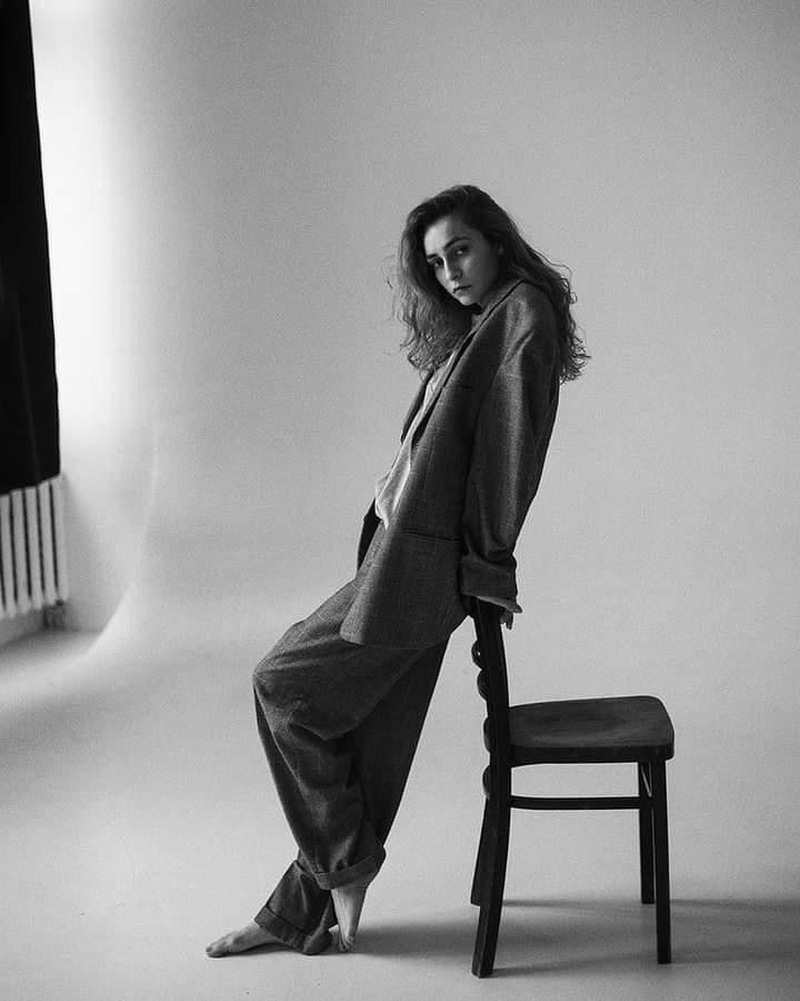 a black and white photo of a woman sitting on a chair