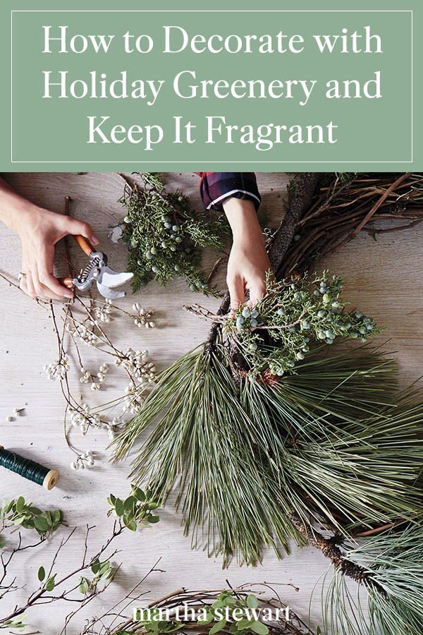 someone is decorating some evergreen branches with scissors and other greenery tools on a table