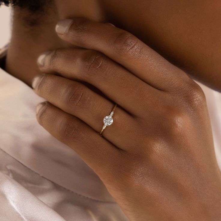 a woman's hand with a diamond ring on it