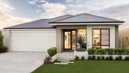 a house that is in the middle of some grass and plants on the front lawn