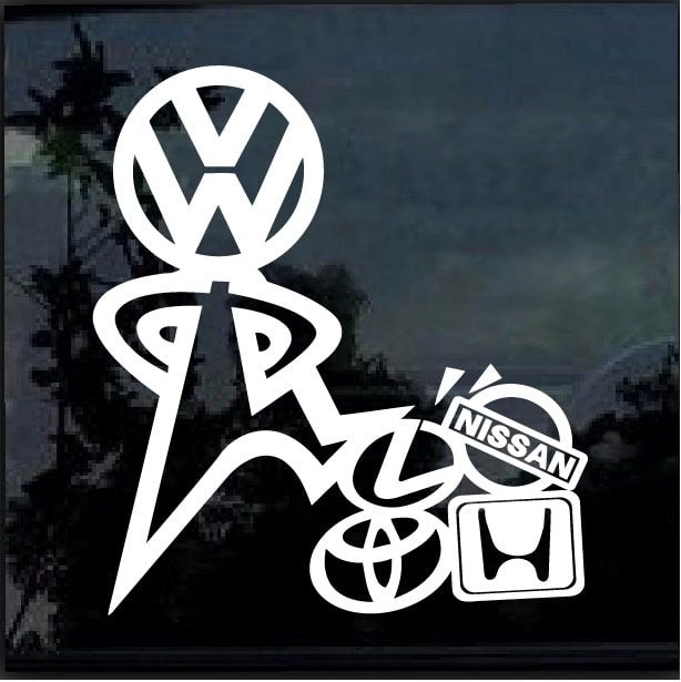 a vw sticker on the side of a car that is parked in front of a tree