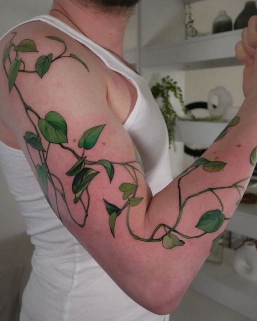 a woman with green leaves on her arm