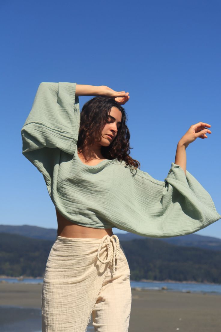 Embrace effortless style with this 100% natural cotton flowy long sleeve crop top, perfect for a beach day or a casual outing. The ultra-soft texture feels like a gentle breeze against your skin, while the breathable fabric keeps you cool under the sun. Its relaxed, flowy fit adds a laid-back charm, making it the ideal companion for your beach look. With its lightweight, natural feel, this top is both durable and chic, perfect for layering over your swimsuit or pairing with your favorite beachwe Ward Robes, Earth Craft, Boho Crop Tops, Environmental Damage, Conscious Fashion, Organic Cotton Fabric, Long Sleeve Crop, Eco Conscious, Physical Health