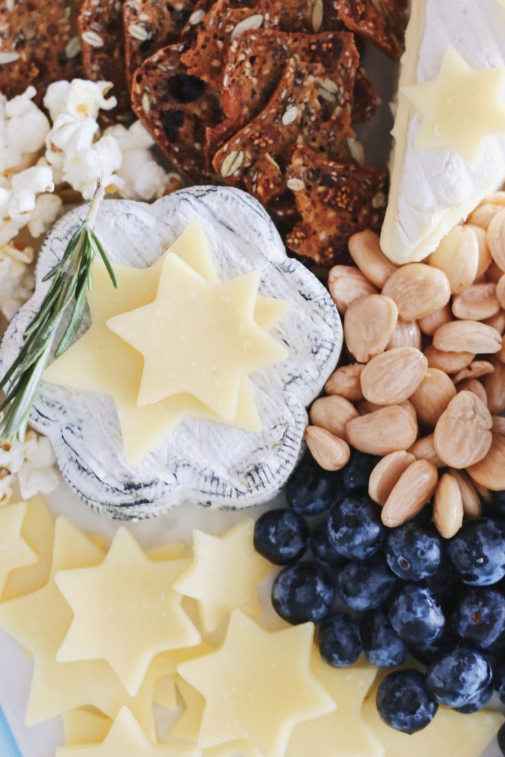 an assortment of food including crackers, blueberries, nuts and other foodstuffs