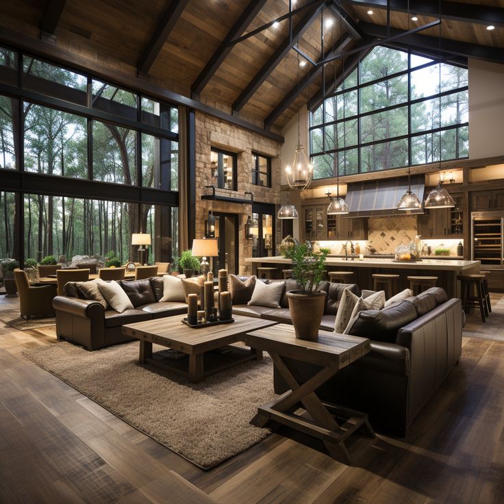 a living room filled with lots of furniture next to large windows and wooden flooring