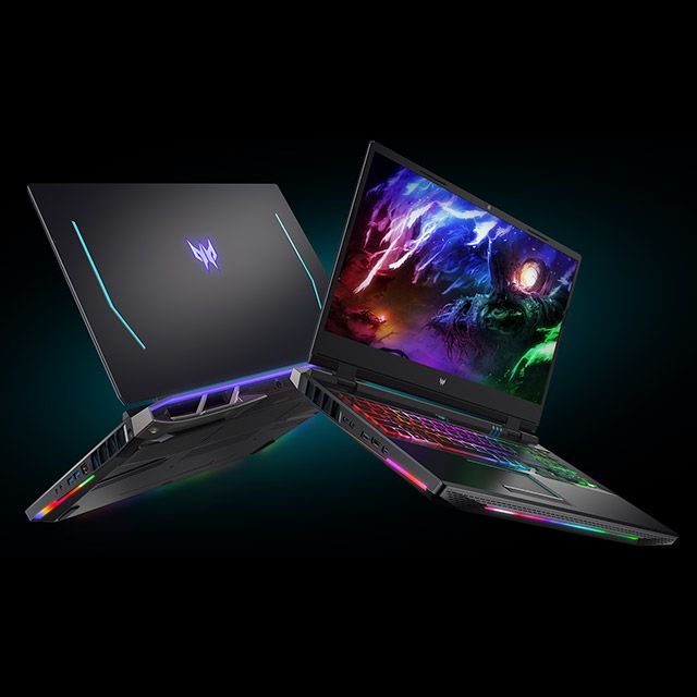 two laptops side by side on a black background, one with an alien theme