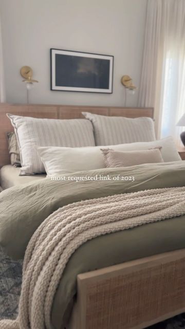 a large bed sitting in a bedroom next to a window