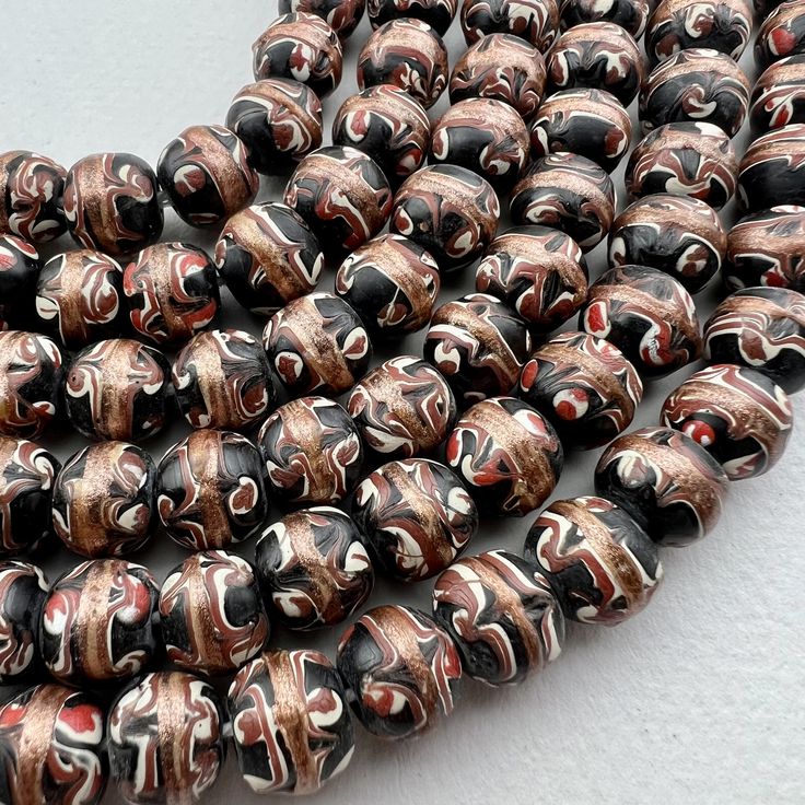 "A strand of handmade Venetian inspired trade bead style beads. a lovely smaller size that work well for bracelets - men love them in our store for their bracelet stacks. 47 beads 17 1/2\" of beads 44cm 10mm diameter on average 1.5 to 2mm hole" Artisan Beaded Bracelets With Spacer Beads As Gift, 8mm Oval Beads For Gifts, Traditional Large Beads For Gifts, Handmade Spiritual Beaded Bracelet With Oval Beads, Spiritual Handmade Beaded Bracelet With Oval Beads, Spiritual Brown Beaded Bracelets With Oval Beads, Spiritual Brown Beaded Bracelet With Oval Beads, Gift Polished Round Beads, Artisan Polished Beads For Gifts