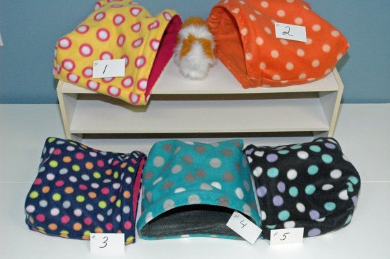 four different colored polka dot hats on display with price tags for each one and the other three