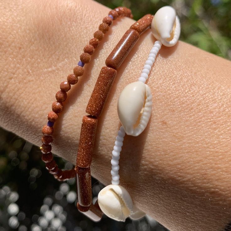 white seed bead bracelet with cowrie shells strung on elastic please gently roll on and off to prolong its life handmade in venice, ca Cowrie Shells, Seed Bead Bracelet, Cowrie Shell, Seed Bead Bracelets, Roll On, Bead Bracelet, Seed Bead, Venice, Seed Beads