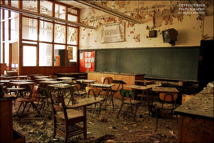 an old classroom with broken chairs and desks